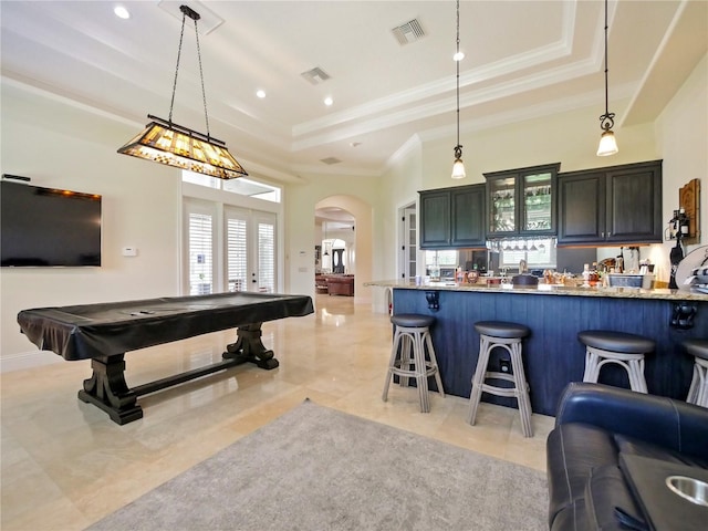 game room featuring a raised ceiling, crown molding, and pool table