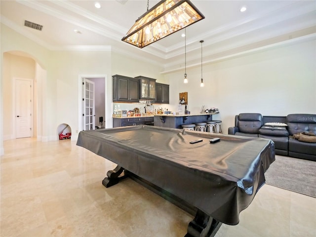 game room with a tray ceiling, ornamental molding, and pool table