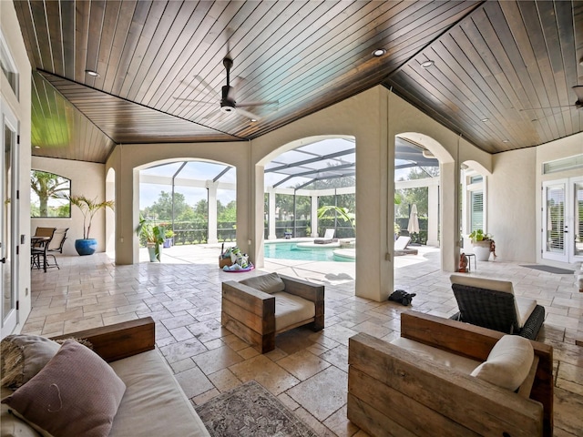 view of patio / terrace with outdoor lounge area, glass enclosure, and ceiling fan