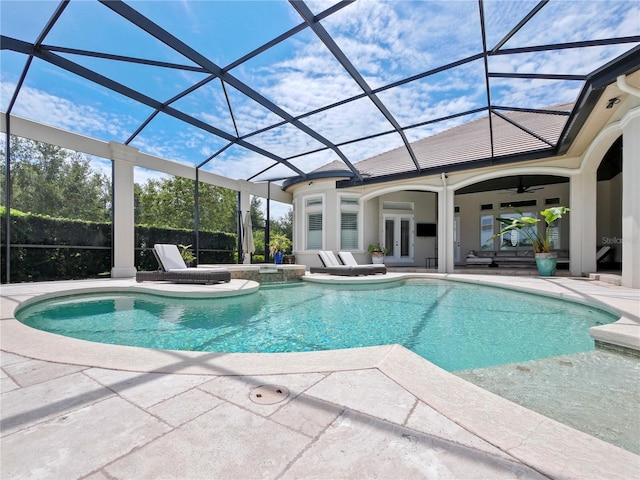 view of pool featuring a lanai, a patio area, ceiling fan, and french doors