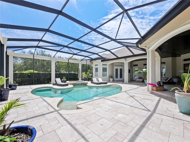 view of pool featuring a lanai, an in ground hot tub, and french doors