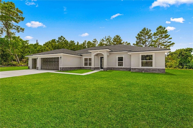 view of front of property with a garage and a front yard