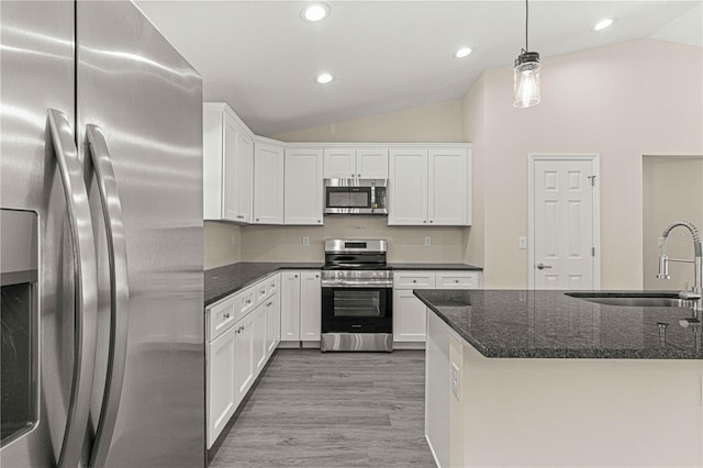 kitchen featuring sink, white cabinetry, appliances with stainless steel finishes, and hanging light fixtures