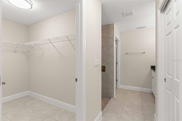 clothes washing area featuring a textured ceiling