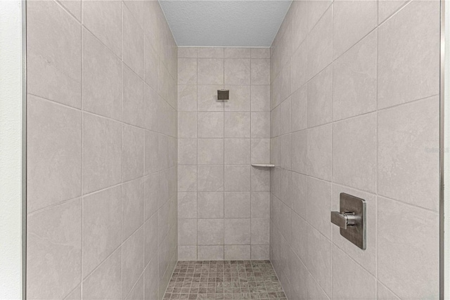 bathroom with tiled shower