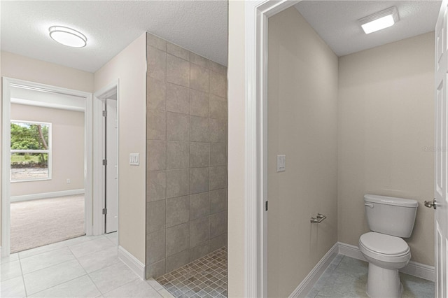 bathroom with a textured ceiling, toilet, and walk in shower