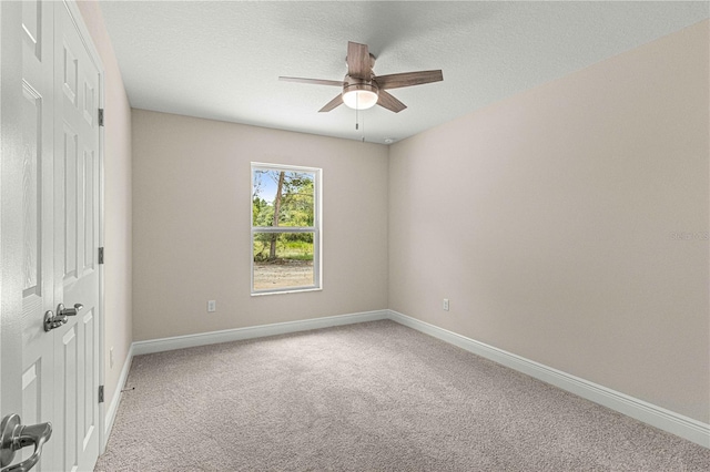 spare room featuring ceiling fan and carpet floors