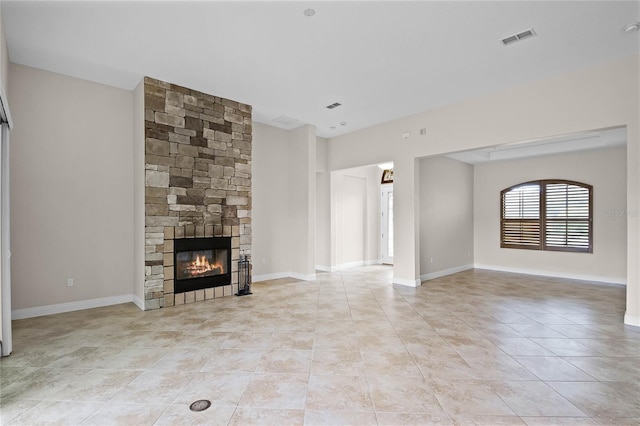 unfurnished living room with light tile patterned floors and a fireplace