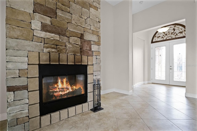 foyer with a fireplace and french doors