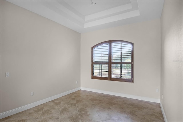 empty room with a raised ceiling