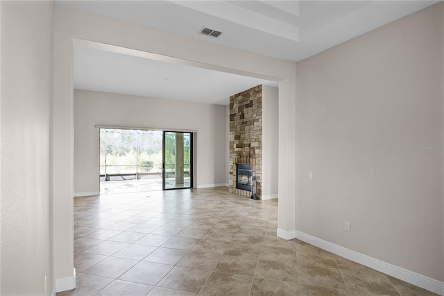 unfurnished living room with light tile patterned floors and a fireplace