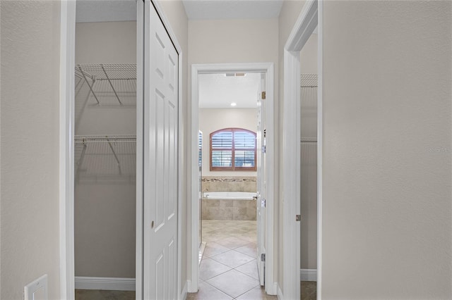 corridor featuring light tile patterned floors