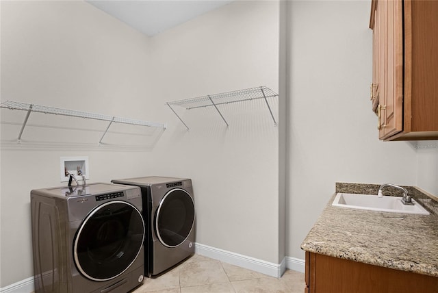 washroom featuring cabinets, light tile patterned flooring, separate washer and dryer, and sink