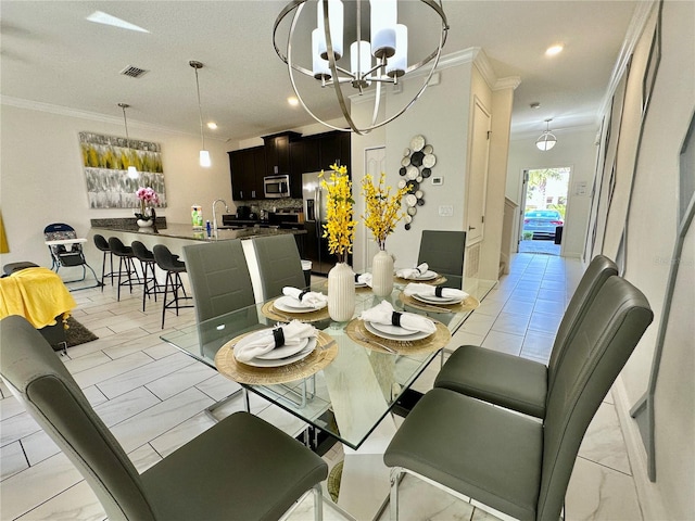 dining space featuring light tile patterned flooring, sink, crown molding, and a chandelier