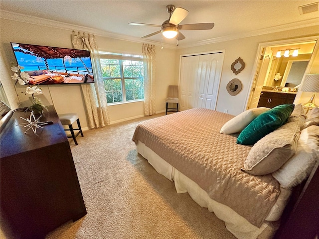 bedroom featuring ornamental molding, carpet floors, ceiling fan, and a closet