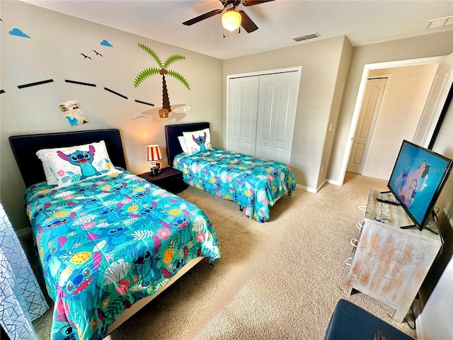 carpeted bedroom with a closet and ceiling fan