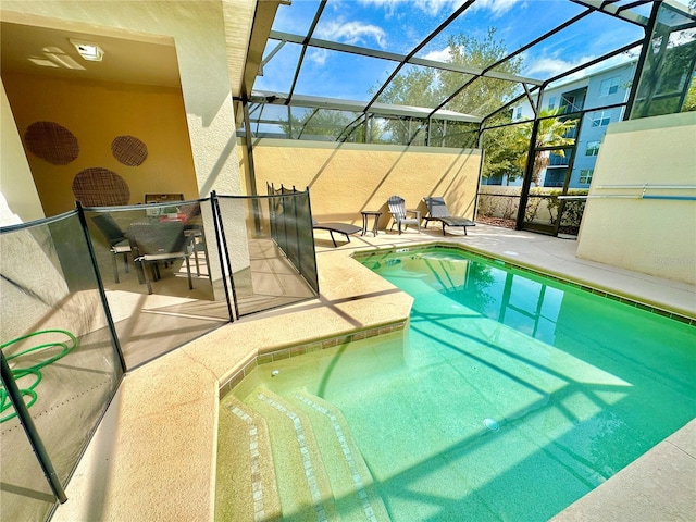 view of pool with a patio area and a lanai