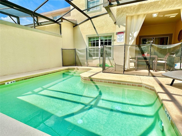 view of pool with a patio area and a lanai