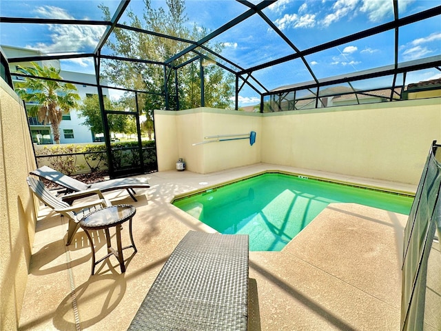 view of swimming pool with a patio and a lanai