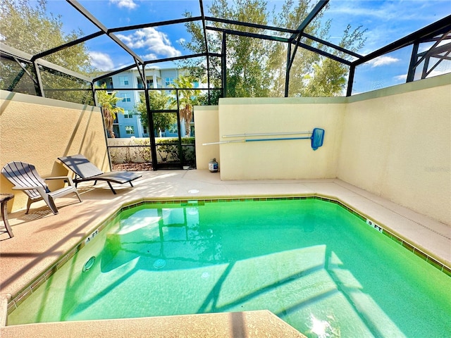 view of swimming pool with a lanai and a patio