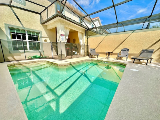 view of pool with a patio and a lanai