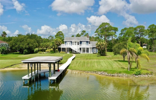 dock area with a lawn and a water view