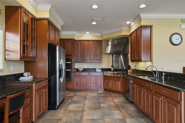 kitchen featuring sink, crown molding, appliances with stainless steel finishes, dark stone countertops, and wall chimney exhaust hood