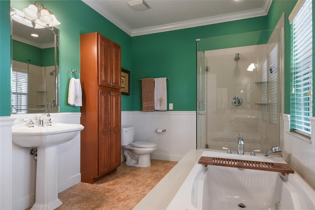 bathroom with crown molding, toilet, a shower with shower door, and tile patterned flooring