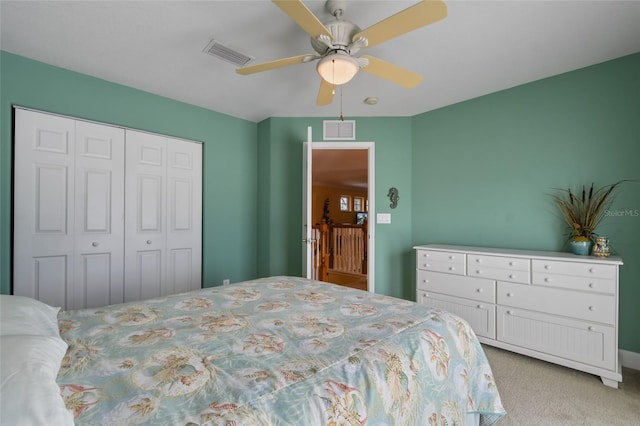 bedroom with light carpet, ceiling fan, and a closet