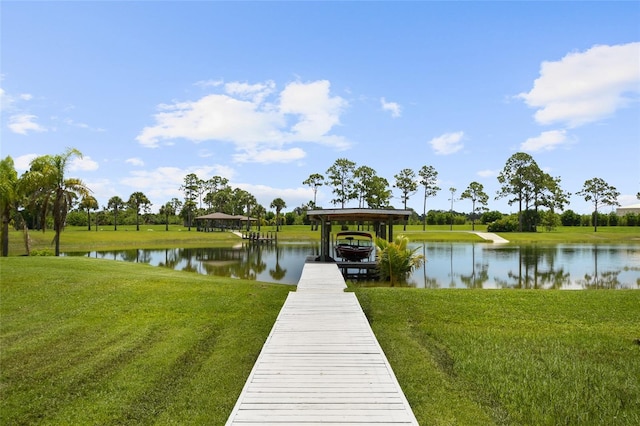 dock area with a water view and a yard