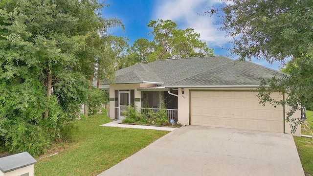 view of front facade featuring a garage, a front yard, and covered porch