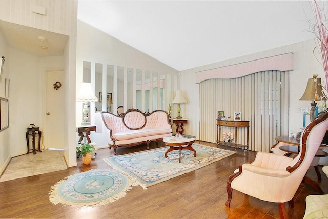 sitting room featuring wood-type flooring and high vaulted ceiling