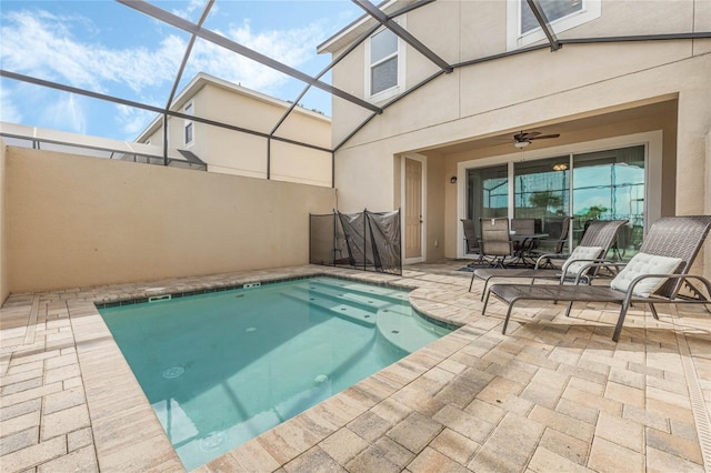 view of pool with a patio area, a lanai, and ceiling fan