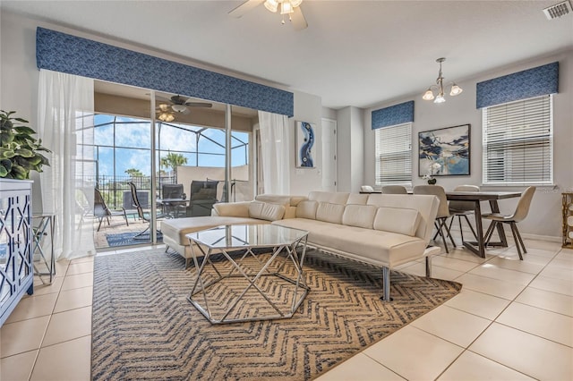 living room with tile patterned flooring and a notable chandelier