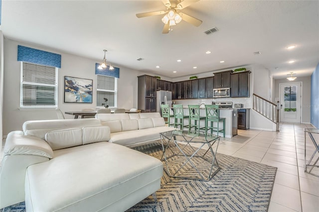 living room featuring ceiling fan and light tile patterned flooring