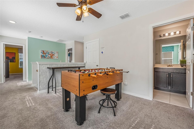 playroom featuring ceiling fan, light carpet, and sink