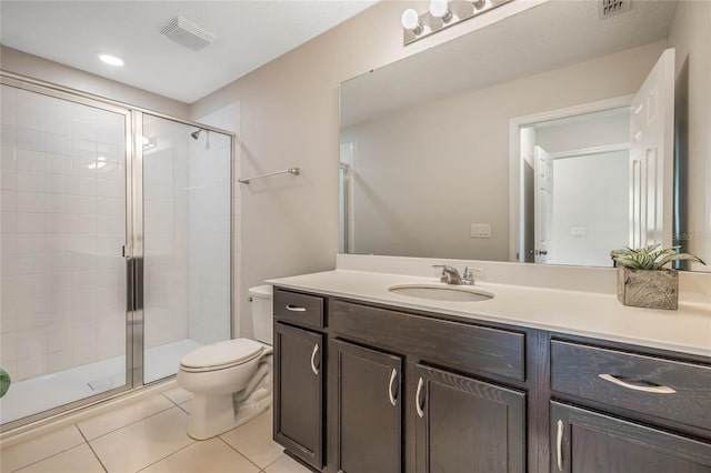 bathroom featuring vanity, walk in shower, tile patterned flooring, and toilet