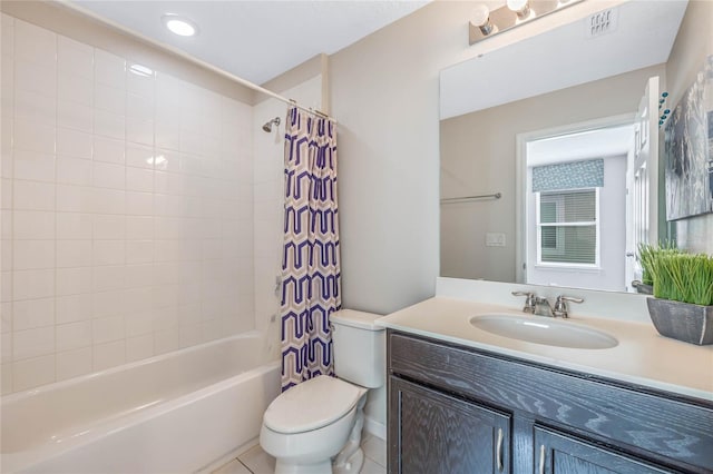 full bathroom featuring toilet, vanity, shower / bath combo with shower curtain, and tile patterned floors