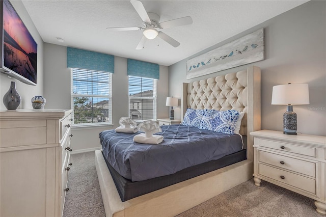 bedroom with ceiling fan, a textured ceiling, and light carpet