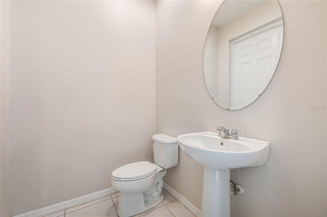 bathroom with toilet and tile patterned flooring