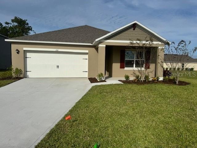 view of front of home with a garage and a front lawn