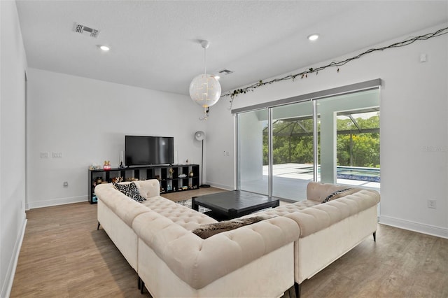 living room featuring hardwood / wood-style floors and a textured ceiling