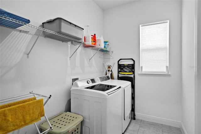 washroom with light tile patterned floors and washing machine and clothes dryer