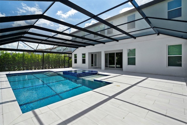 view of pool featuring an in ground hot tub, a patio area, and a lanai