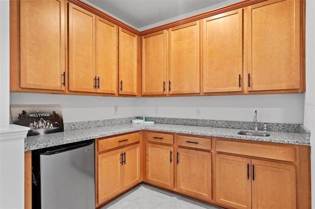 kitchen featuring sink, light tile patterned flooring, stainless steel fridge, and light stone countertops