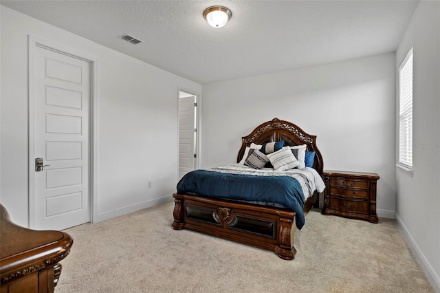 bedroom featuring light carpet and multiple windows