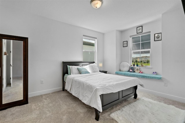 carpeted bedroom with multiple windows