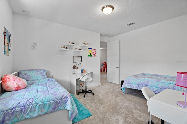 carpeted bedroom with a textured ceiling