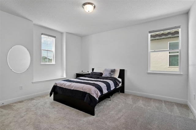 carpeted bedroom with a textured ceiling