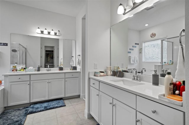 bathroom featuring vanity, walk in shower, and tile patterned flooring